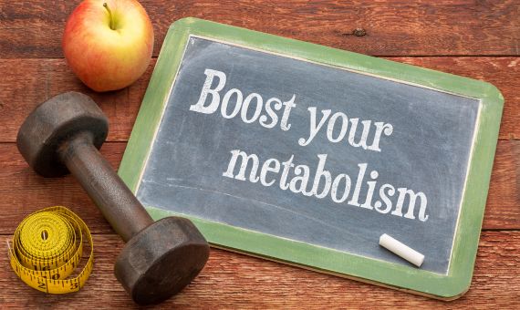 boost your metabolism signe with red apple, a weight and tape measure 